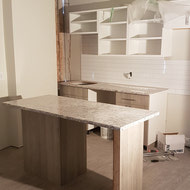 Counters and Cabinetry being installed in an 02 unit.