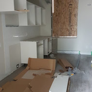 Cabinetry being installed in a studio suite.