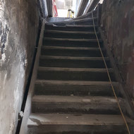 Old staircase in the back of the building connecting the old store to the main basement area.