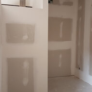 Drywall going up and taping being done in suites.