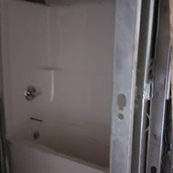 Tub surround being installed in one of the suites.