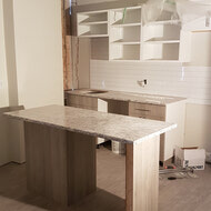 Counters and Cabinetry being installed in an 02 unit.