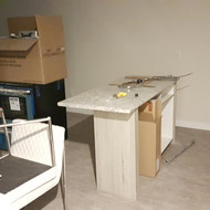 Assembly work being done for some appliances and cabinetry.