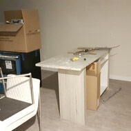 Assembly work being done for some appliances and cabinetry.