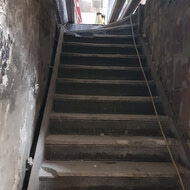 Old staircase in the back of the building connecting the old store to the main basement area.